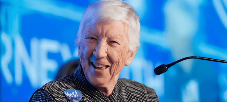 Sister Rosemary Flanigan smiling at a lectern.