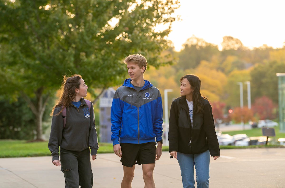 Three students walking on campus