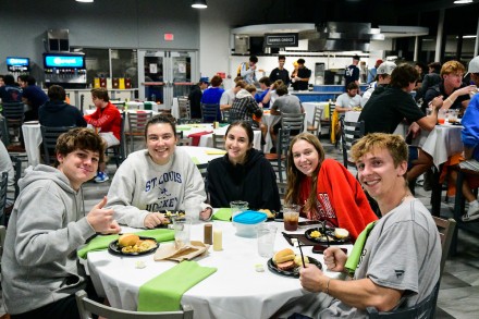 Students eating in the cafeteria, smiling