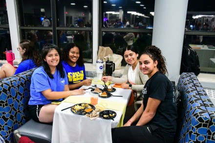 Four girls eating at a booth in the cafeteria